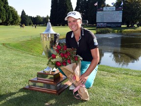 Brooke Henderson poses with the trophy on the 18th hole after winning the Cambia Portland Classic in Portland, Ore., on Sunday, Aug. 16, 2015. (Steve Dykes/AP Photo)
