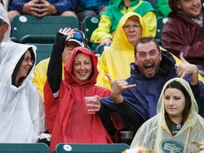 Enthusiastic Edmonton Eskimos fans are seen as the team plays the  Winnipeg Blue Bombers on a rainy day during CFL action at Commonwealth Stadium in Edmonton, Alta.. on Saturday July 25, 2015. Ian Kucerak/Edmonton Sun