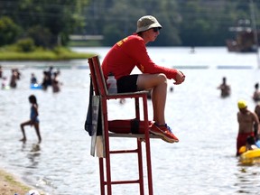 An City of Ottawa lifeguard keeps an eye on swimmers during a heatwave at Mooney's Bay Beach in Ottawa on Sunday, Aug. 16, 2015. Environment Canada issued a heat warning for Ottawa, with temperatures around 30 C, feeling like 40 C with the humidex. THE CANADIAN PRESS/Justin Tang