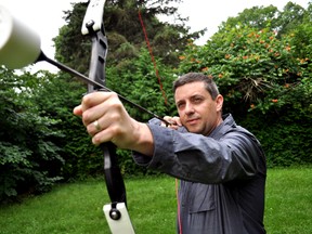 Glen Gorman, owner of The Hood Archery Games, draws a bow and arrow in London Ont. August 18, 2015. The Hood Archery Games, the first archery tag location in London, is expected to open in September. CHRIS MONTANINI\LONDONER\POSTMEDIA NETWORK