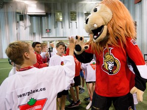 Ottawa Senators mascot "Spartacat" high-fives youth after the club launched the Grow the Game minor hockey program at the Bell Sensplex on Wednesday August 19, 2015. The Senators, in conjunction with Hockey Eastern Ontario and Hockey Outaouais along with the Ottawa Senators Foundation are working together to see an increase in enrollment in minor hockey. Errol McGihon/Ottawa Sun/Postmedia Network