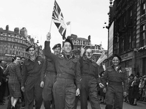 Canadian soldiers celebrate VE-Day at Piccadilly Circus, London, May 8,1945, in this handout photo provided by Library and Archives Canada. Seventy years ago, following the suicide of Nazi leader Adolf Hitler, Germany's head of state Karl Donitz signed his country's surrender to Allied forces in Reims, France on May 7, 1945 and in Berlin on May 8, 1945.  REUTERS/Lieut. Arthur L. Cole/Canada Department of National Defence/Library and Archives Canada/PA-176695/Handout