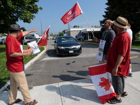 Airport Taxi drivers block a Blueline cab at the headquarters of Coventry Connections, the company that in conjunction with the Ottawa Airport Authority wants to charge drivers $5.00 per fare at the airport. Wednesday August 19, 2015. Errol McGihon/Ottawa Sun/Postmedia Network