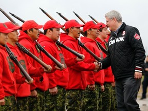 Canada's Prime Minister Stephen Harper greets Canadian Rangers after arriving in Pond Inlet, Nunavut August 25, 2014. REUTERS/Chris Wattie