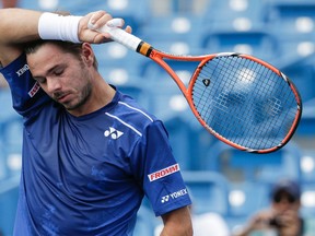 Stan Wawrinka wipes sweat from his forehead during his match against Borna Coric at the Western & Southern Open Wednesday, Aug. 19, 2015, in Mason, Ohio. (AP Photo/John Minchillo)