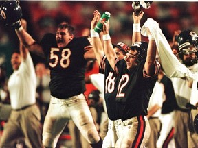 Chicago Bears' quarterback Erik Kramer (12) celebrates along with Chris Villarrial and backup quarterback Steve Stenstrom after defeating the Miami Dolphins Oct. 27, 1997. (Reuters)