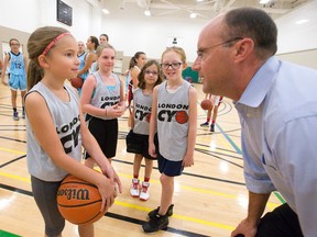 London Mayor Matt Brown talks with junior basketball player Katelyn Schmidt, 10, at a press conference to announce the four Ontario Basketball Association Provincial Championship weekends, taking place in early 2016, at the Carling Heights Optimist Community Centre in London on Thursday. (CRAIG GLOVER, The London Free Press)