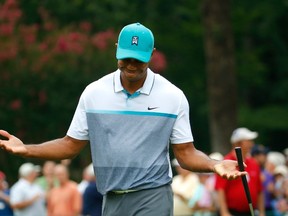 Tiger Woods reacts after sinking a birdie putt on the 13th green during the first round of the Wyndham Championship at Sedgefield Country Club on August 20, 2015 in Greensboro, North Carolina.   Kevin C. Cox/Getty Images/AFP
