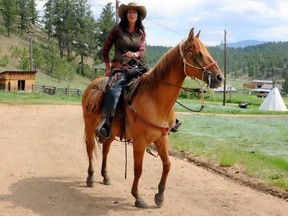 Paula Gonzalez Del Real, co-manager of Tarryall River Ranch in Lake George, Colo., gets ready to lead a trail ride. PAT LEE /SPECIAL TO POSTMEDIA NETWORK