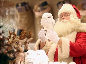 Santa Claus poses for a photograph in the Christmas Shop, at Selfridges department store, on Oxford street, London August 3, 2015. (REUTERS/Paul Hackett)