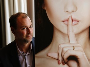 Ashley Madison founder Noel Biderman poses with a poster during an interview at a hotel in Hong Kong in this August 28, 2013 file photo. Emails sent by the founder of infidelity website AshleyMadison.com  appear to have been exposed in a second, larger release of data stolen from its parent company, Vice Media's online technology site Motherboard reported August 20, 2015.  REUTERS/Bobby Yip/Files