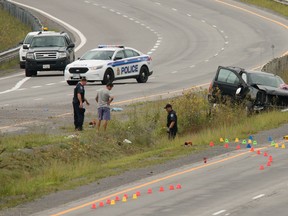 Investigators on the scene on Hwy. 174 where a highway maintenance worker died Thursday afternoon after he was struck by an SUV.  Thursday August 20, 2015. Errol McGihon/Ottawa Sun/Postmedia Network