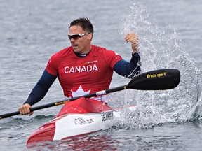 Canada's Mark de Jonge splashes the water as he celebrates his gold medal in the men's K1 200m kayak race at the 2015 Pan Am Games in Welland, Ont., Tuesday, July 14, 2015. THE CANADIAN PRESS/Aaron Lynett