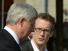 Conservative Leader Stephen Harper talks to his current chief of staff Ray Novak as he makes a campaign stop at the Vancouver shipyards in Vancouver, B.C. on Wednesday, August 12, 2015. THE CANADIAN PRESS/Sean Kilpatrick