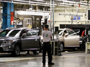 Workers assemble a Lexus SUV at the Cambridge Toyota plant. The automaker reported a first quarter profit of US$6.16 billion. (Canadian Press file photo)