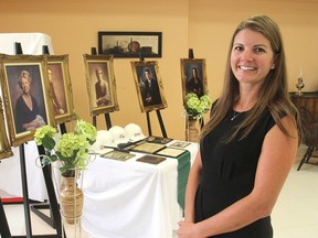 Angela Gibson, assistant administrator at the Helen Henderson Care Centre in Amherstview, stands in front of portraits of members of the Gibson family, which has been in the health-care business in the area for 50 years. A celebration was held on Thursday. (Michael Lea/The Whig-Standard)