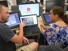 Chris Pellow, a professor in Fanshawe College?s new video game design and development program, talks with supervisor Michelle Giroux in a new lab at the college?s Centre for Digital and Performance Arts on Dundas Street in downtown London Thursday. (CRAIG GLOVER, The London Free Press)