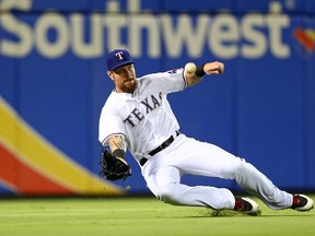 Josh Hamilton of the Texas Rangers makes a sliding catch during a game against the Houston Astros at Globe Life Park on August 3, 2015 in Arlington, Tex. (Sarah Crabill/Getty Images/AFP)