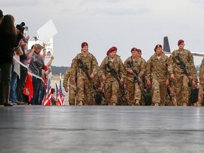 Paratroopers with the 1st Brigade Combat Team, 82nd Airborne Division, march up the ramp as they return home from Afghanistan at Pope Army Airfield in Fort Bragg, North Carolina November 5, 2014. A spokesman for the 82nd Airborne Division said 18 military paratroopers were struck by lightning during a training exercise on Wednesday. REUTERS/Chris Keane