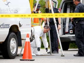 Prof. Scott Fairgrieve from Laurentian University's forensic science program prepares to be lowered into a manhole in this file photo. Gino Donato/The Sudbury Star