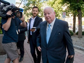 Former Conservative senator Mike Duffy arrives at the courthouse in Ottawa, for the second day of testimony by Benjamin Perrin, former legal adviser for the Prime Minister's Office, on Friday, Aug. 21, 2015. Duffy is facing 31 charges of fraud, breach of trust, bribery, frauds on the government related to inappropriate Senate expenses. THE CANADIAN PRESS/Justin Tang