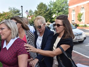 Former Ravens cheerleader Molly Shattuck, second from right, arrives at the Sussex County Courthouse in Georgetown, Del., for sentencing, Friday, Aug. 21, 2015. (Kim Hairston/The Baltimore Sun via AP)