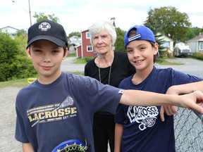 Jared Eadie-Chartrand, 12, left, his brother, Ashton 10, and his great-grandmother, Lucy Eadie, assisted a woman and her daughters who were involved in car a accident near Eyre Playground in Sudbury, Ont. on Thursday, August 20, 2015. John Lappa/Sudbury Star/Postmedia Network