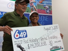 Rod Holinaty, and Verna Tremblay of La Ronge, Sask., are seen collecting their $14.2 Million cheque, after winning the Aug. 5, 2015 Lotto 649 draw, on Friday, Aug. 21, 2015. (THE CANADIAN PRESS/HO)