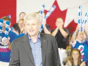 Prime Minister Stephen Harper addresses supporters during an evening rally at the Best Western Lamplighter Inn in London on Wednesday. His rousing, confident address to party faithful was a far cry from the planned, structured address he delivered earlier that same day when the ongoing Mike Duffy trial cast a pall over his responses to five questions allotted to media. (Free Press file photo)