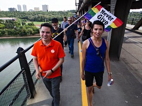 Federal NDP candidate Aaron Paquette, left, chats with event organizer Chevi Rabbit as they cross the High Level Bridge during the From Hate to Hope march in Edmonton, Alta. on Sunday, Aug. 2, 2015. Paquette wrote in 2013, “Don’t kid yourself. Canada wasn’t born of debate but of slaughter, treachery and theft. The Charter is written in blood.” Codie McLachlan/Edmonton Sun/Postmedia Network