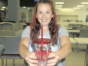 Samantha Reed/The Intelligencer 
Loyalist College student government president Jillian Robinson holds a refillable water bottle that is given to every student attending the school. College officials say they have no immediate plans to ban the sale of plastic water bottles on the campus.
