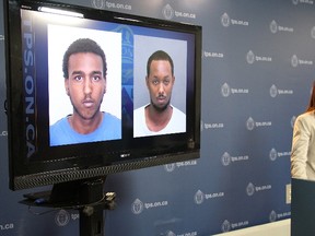 Toronto Police homicide Det.-Sgt. Joyce Schertzer announces a Canada-wide warrant has been issued for Mohamud Abdwali Dirie (pictured with blue shirt) on Aug. 21, 2015. Police are also searching for Hassan Abdulle (pictured with white shirt) in the death of Kabil Abdulkhadir on Bay St. Aug. 9. (Nick Westoll/Toronto Sun)