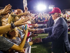 MOBILE, AL- AUGUST 21: Republican presidential candidate Donald Trump greets supporters after his rally at Ladd-Peebles Stadium on August 21, 2015 in Mobile, Alabama. The Trump campaign moved tonight's rally to a larger stadium to accommodate demand.   Mark Wallheiser/Getty Images/AFP