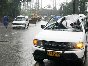 A resident drives a vehicle damaged by a fallen electric post after Typhoon Goni battered Baguio city in northern Philippines August 21, 2015. The Philippine Atmospheric, Geophysical and Astronomical Service Administration (PAGASA) state weather bureau reported on Friday that Typhoon Goni maintained its strength of maximum winds of 170 kilometers per hour (kph) near the centre and gusts of up to 205 kph, while several areas in the northern Philippines were placed under storm warning signals. REUTERS/Harley Palanchao
