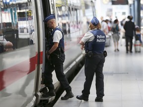 Belgian police officers enter a train during a patrol at the Thalys high-speed train terminal at Brussels Midi/Zuid railway station, August 22, 2015. A machine gun-toting attacker wounded three people on a high-speed train in France on Friday before being overpowered by passengers who included an American soldier.  REUTERS/Francois Lenoir