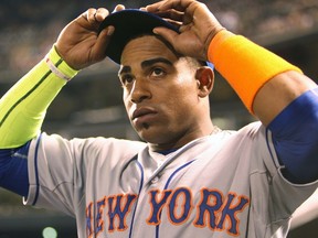 Yoenis Cespedes, adjusting his cap during the fifth inning of his monster night at Coors Field on Friday, has more than justified his high bid price in NL-only leagues. (Chris Humphrey, USA Today Sports)