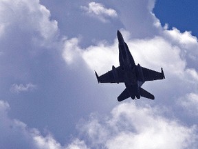 Its a bird, it's and plane, it's a Royal Canadian Air Force (RCAF) CF-18 Hornet fighter jet as it made a high speed pass over Edmonton's river valley in Edmonton, Alta., on Monday, June 2, 2014. The fighter made a pass over in of a Canadian Military charity golf tournament being held at the Royal Mayfair Golf Club. Ian Kucerak/Edmonton Sun/QMI Agency