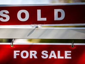 A "For Sale" sign stands in front of a home that has been sold in Toronto in June 2015. (REUTERS/Mark Blinch)