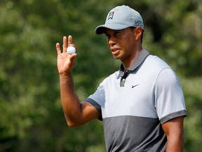 Tiger Woods waves to the gallery after making his par putt on the 10th hole during the third round of the Wyndham Championship at Sedgefield Country Club in Greensboro, N.C., on Saturday, Aug. 22, 2015. (Kevin C. Cox/Getty Images/AFP)