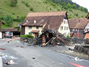 Parts of one of the two planes which crashed during an air show are seen in the village of Dittingen, Switzerland, in this handout photo provided by Kantonspolizei Basel Landschaft on August 23, 2015. Two small planes crashed at an air show in Dittingen, Switzerland, on Sunday, killing at least one person, police said. REUTERS/Kantonspolizei Basel Landschaft/Handout via Reuters