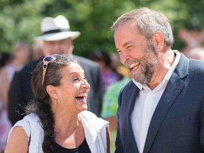 NDP Leader Thomas Mulcair shares a laugh with his wife Catherine Pinhas during a federal election campaign stop in Saint Jerome, Que., on Saturday, August 22, 2015. THE CANADIAN PRESS/Graham Hughes