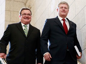 Canada's Prime Minister Stephen Harper (R) and Finance Minister Jim Flaherty walk to the House of Commons to deliver the budget on Parliament Hill in Ottawa in this file photo February 11, 2014.   REUTERS/Blair Gable/Files