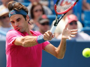 Roger Federer, of Switzerland, returns the ball to Novak Djokovic, of Serbia, during a final match at the Western & Southern Open tennis tournament, Sunday, Aug. 23, 2015, in Mason, Ohio. (AP Photo/John Minchillo)