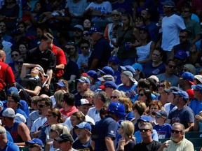 A fan is tended to by medical personnel after being struck with a foul ball during the game between the Chicago Cubs and the Atlanta Braves at Wrigley Field on August 23, 2015 in Chicago, Illinois.   Jon Durr/Getty Images/AFP