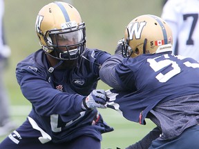 Winnipeg Blue Bombers linebacker Jasper Simmons (left) works out against defensive end Jamaal Westerman during CFL football practice in Winnipeg, Man. Sunday, August 23, 2015. (Brian Donogh/Winnipeg Sun/Postmedia Network)