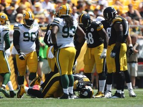 Pittsburgh Steelers center Maurkice Pouncey (53) lays on the field after being injured against the Green Bay Packers during the first half at Heinz Field. Jason Bridge-USA TODAY Sports