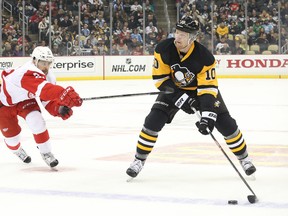 Pittsburgh Penguins defenseman Christian Ehrhoff (10) skates with the puck against pressure from Detroit Red Wings left wing Tomas Tatar (21) during the second period at the CONSOL Energy Center. Detroit won 5-1. Charles LeClaire-USA TODAY Sports