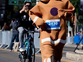 Kevin Yoo runs the Half Marathon portion of the Edmonton Marathon in a gingerbread man costume, in Edmonton Alta. on Saturday Aug. 23, 2015. Yoo was raising money for charity and attempting to break a world record. David Bloom/Edmonton Sun/Postmedia Network