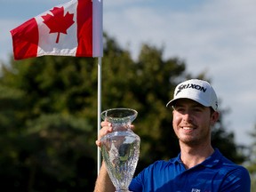 Sam Ryder raises the championship trophy after winning the National Capital Open at the Hylands Golf Club after two playoff holes in Ottawa on Sunday August 23, 2015. Errol McGihon/Ottawa Sun/Postmedia Network