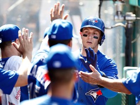 Blue Jays’ Troy Tulowitzki (right) is congratulated after scoring on a single by Edwin Encarnacion during the eighth inning on Sunday against the Los Angeles Angels in Anaheim. (AP/PHOTO)